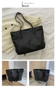 Detail of black faux leather tote bag with classic diamond woven texture and thin straps