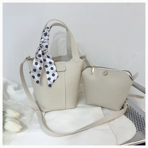 Detail view of cream leather bucket bag set with polka dot scarf and inner pouch