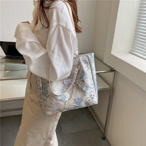 Large capacity tote bag with elegant blue floral embroidery and white shoulder straps