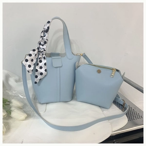 Light blue bucket bag and matching pouch set with decorative polka dot silk scarf detail