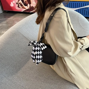 Minimalist black leather square crossbody bag with stylish checkered silk scarf accent