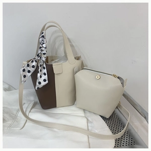Detail of contrast bucket bag set with polka dot scarf handle and inner zip pouch