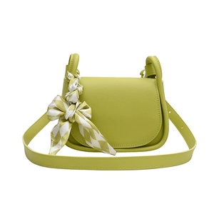 Avocado green faux leather crossbody saddle bag with decorative patterned scarf handle