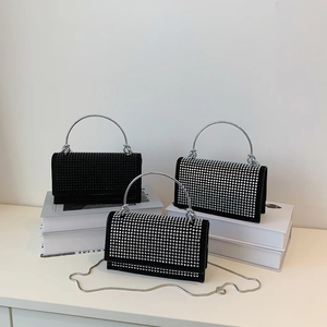 Elegant rhinestone evening handbag with round metal handle and delicate chain strap
