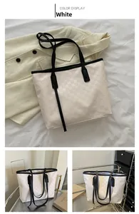 Detail of white checkered tote bag with black straps and spacious interior view