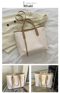 Detail of khaki patchwork tote bag with checkerboard embossing and long handles