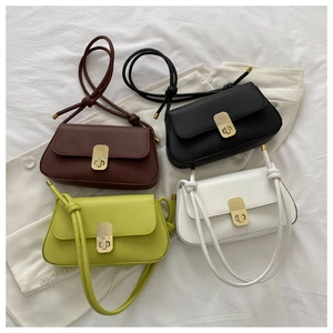 Detail of minimalist rectangular shoulder bags in coffee, black, green, and white colors