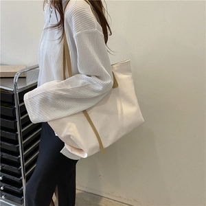 Minimalist large canvas tote bag in off-white with khaki straps for daily commute