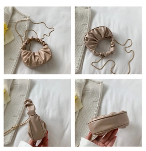 Detail view of beige ruched cloud bag showing golden chain and pleated PU leather