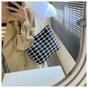 Detailed view of checkered tweed tote bag with thick cotton rope shoulder strap