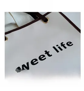 Dettaglio della borsa shopper bianca con scritta sweet life e finiture dorate