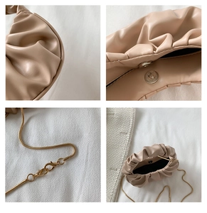 Detailed macro view showing the pleated texture, magnetic closure, and gold chain of the bag