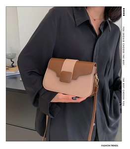 Close-up of brown and apricot patchwork PU leather shoulder bag with a metal buckle
