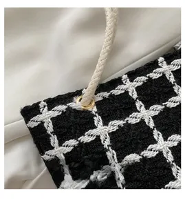 Detail of tweed checkered bag showing high-quality woven texture and golden eyelet