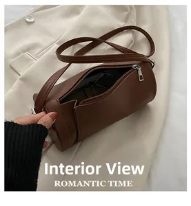 Detail of dark brown cylindrical crossbody bag interior showing storage space for sunglasses