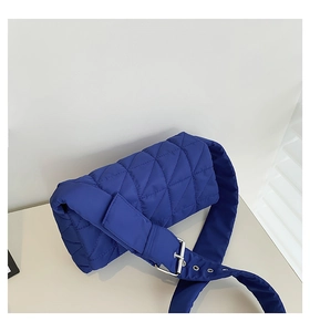Detail of navy quilted shoulder bag with puffy nylon texture and silver buckle