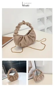 Detail view of khaki pleated cloud bag featuring soft texture and golden chain strap