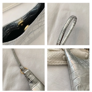 Detailed close-up of silver stone pattern bag with magnetic closure and metallic link rings