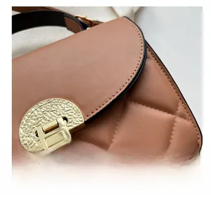 Detailed view of the diamond-quilted leather texture and gold semicircular buckle