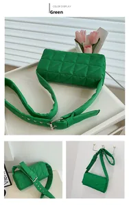 Detail view of grass green quilted crossbody bag with adjustable padded shoulder strap