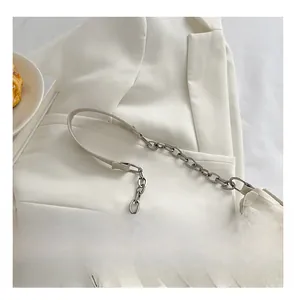 Detail of the chain-leather strap and checkered texture on a canvas underarm bag
