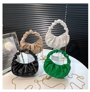 Close-up of ruched cloud bags in four colors with detachable gold chain straps