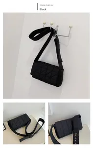 Detail view of black quilted puffer shoulder bag with wide strap and geometric patterns