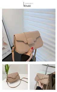 Detail view of khaki square crossbody bag featuring a classic flap and metal hardware