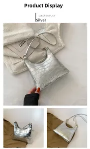 Detail showing the silver faux crocodile texture and crescent curved design on the bag