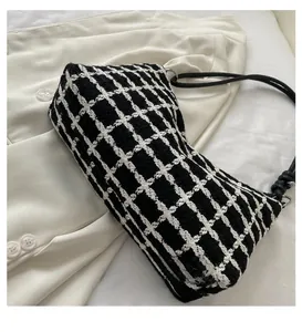 Detail of checkered tweed handbag featuring a cylindrical base and premium stitching