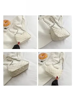 Detail view of cream checkered underarm bag showing front, side and bottom angles