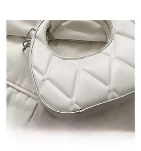 Detail shot of white quilted hobo bag featuring geometric stitching and premium PU texture