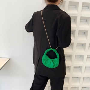 Chic green pleated cloud bag with gold chain strap shown on black blazer outfit