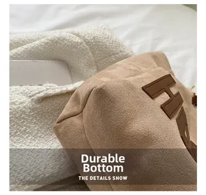 Close-up of the wear-resistant bottom and suede texture of this brown tote bag