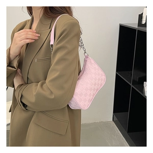 Detail shot of a soft pink checkered underarm bag with a metal chain shoulder strap