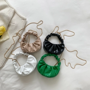 Pleated dumpling bag in beige black white and green with gold chain and handle