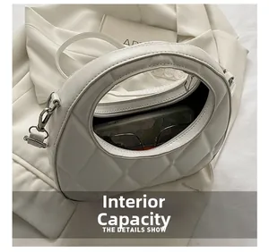 Macro view showing the internal capacity and quilted leather texture of the white handbag