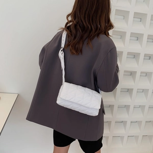 Minimalist white quilted shoulder bag with diamond pattern and adjustable wide strap