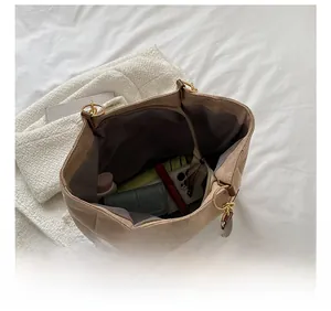 Detailed interior of a large khaki tote bag showing organized daily essentials and storage
