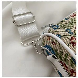 Detail of silver metal hook and floral jacquard fabric on the vintage shoulder bag