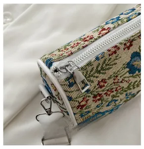 Detail of vintage floral jacquard pattern with silver metal zipper and white piping