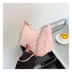 Detailed view of pink plaid shoulder bag featuring chunky silver chain and zip closure