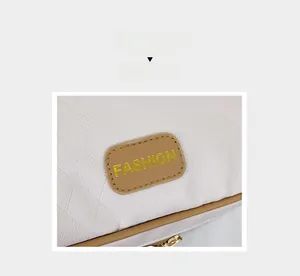Nahaufnahme der weißen gesteppten Ledertasche mit braunem Lederpatch und Goldakzenten
