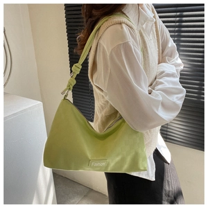 Detail of lime green shoulder bag with checkered texture and knotted strap design