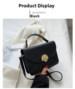 Detail of black quilted crossbody bag featuring a vintage gold metal lock and handle