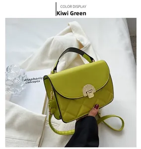 Detail of kiwi green quilted crossbody bag featuring a vintage gold metal lock and handle