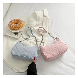 Detail of woven checkerboard texture on canvas baguette bags in light blue and pink