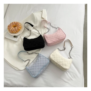 Checkered canvas underarm bags in four colors with chain straps on a white fabric background