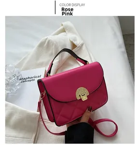 Detail view of rose pink quilted leather bag with vintage golden circular buckle