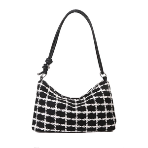 Classic black and white checkered tweed shoulder bag with knotted leather strap